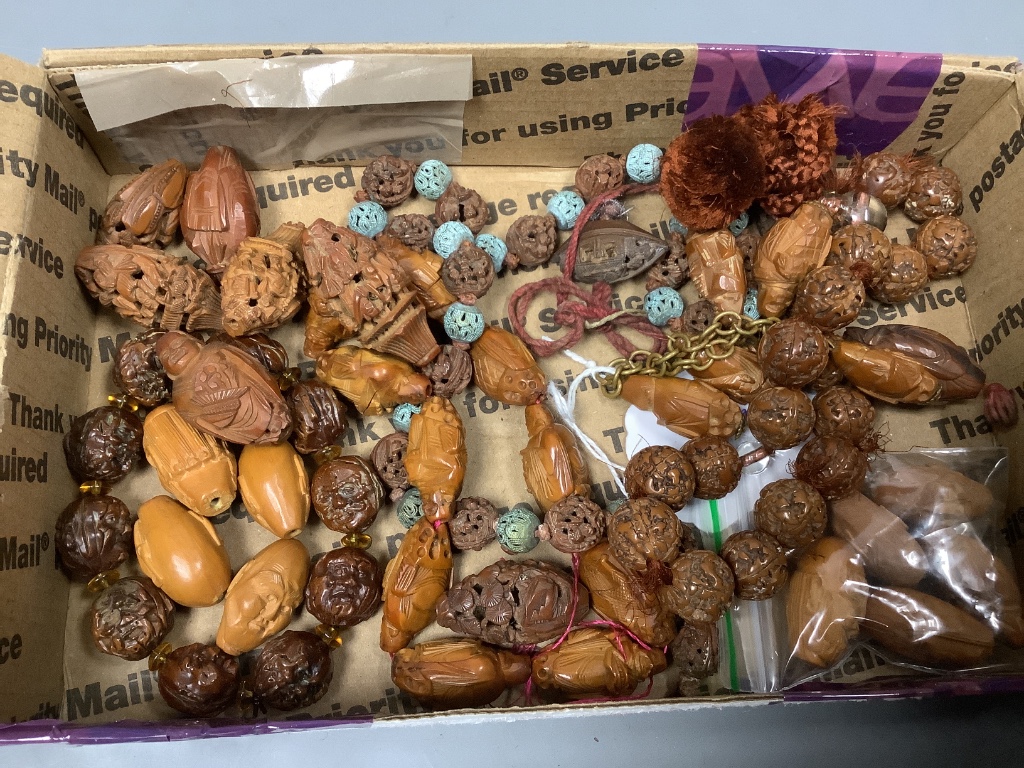 Various Chinese peach stone and nut carvings, bead necklaces, bangles etc